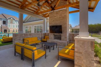Outdoor living room with tv and fireplace